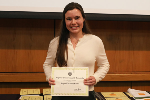 Student Megan Elizabeth Kolbe, class of 2026, holding a certificate for the A.D. Williams Award