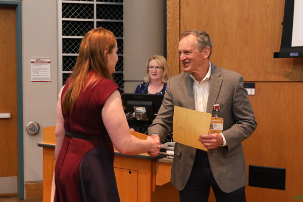 Ron Clark, M.D. Distinguished Service Award handed to award winner and medical education student, Anne Skelton